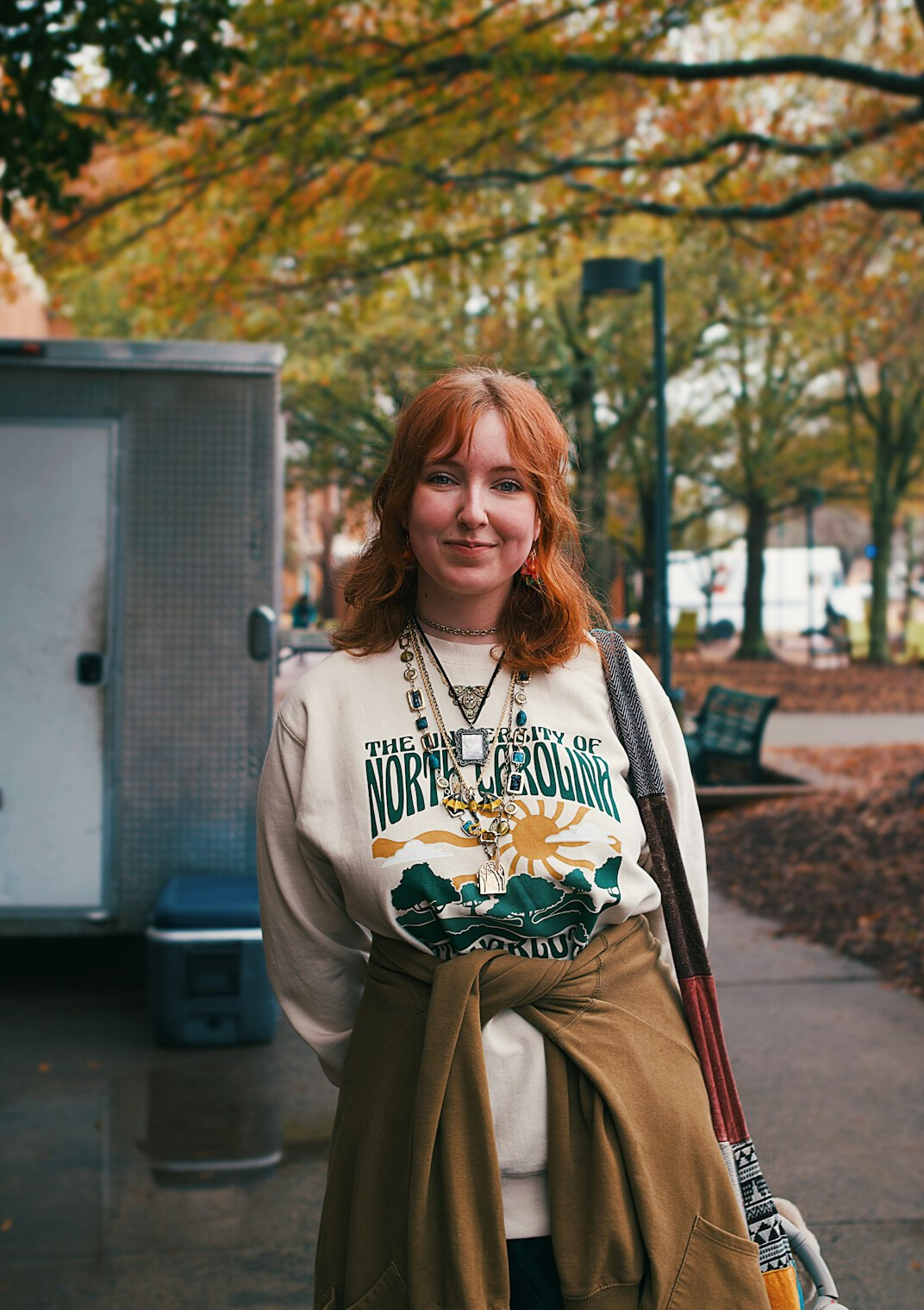 Woman counselor with auburn hair in beige cardigan smiling portrait